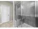 Large walk-in shower with gray tile and seat at 4323 Pond Pine Trl, Morrisville, NC 27560