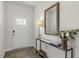 Bright entryway with a console table, mirror, and wood-look floors at 437 Ashley Run, Sanford, NC 27330