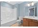 Bathroom with tub, toilet and wood vanity at 444 S Blount St # 316, Raleigh, NC 27601