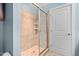 Stand-up shower with tile surround in a full bathroom at 444 S Blount St # 316, Raleigh, NC 27601
