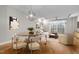 Open concept dining area with a round table and modern light fixture at 444 S Blount St # 316, Raleigh, NC 27601