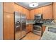Stainless steel appliances and wood cabinets in kitchen at 444 S Blount St # 316, Raleigh, NC 27601