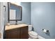 Well-appointed powder room with dark brown vanity and a modern toilet at 444 S Blount St # 316, Raleigh, NC 27601