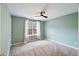 Bright bedroom with carpet, neutral walls, and large window at 4533 Sugarbend Way, Raleigh, NC 27606