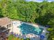 Aerial view of community pool and clubhouse nestled in a wooded area at 4533 Sugarbend Way, Raleigh, NC 27606