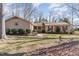 Front view of a ranch home with a well-maintained lawn and landscaping at 5416 Fairoaks Rd, Durham, NC 27712