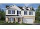 Two-story house with white siding, brick accents, and a two-car garage at 553 Tim Currin Rd, Lillington, NC 27546