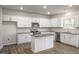 Modern kitchen with white cabinets, granite countertops, and island at 553 Tim Currin Rd, Lillington, NC 27546