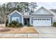 Ranch style home with blue siding, white garage door, and landscaping at 603 Tuttle Rd, Durham, NC 27703