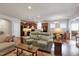 Bright living room with hardwood floors, leather seating, and kitchen views at 603 Tuttle Rd, Durham, NC 27703