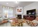 Living room with fireplace, hardwood floors, and comfortable seating at 603 Tuttle Rd, Durham, NC 27703