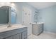 Bathroom with gray vanity, marble floor, and a double sink at 706 Sleepy Creek Dr, Durham, NC 27713