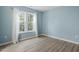 Spacious bedroom with light blue walls and wood-look floors at 706 Sleepy Creek Dr, Durham, NC 27713