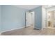 Light blue bedroom with wood-look floors and access to bathroom at 706 Sleepy Creek Dr, Durham, NC 27713