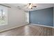 Spacious bedroom with wood-look floors, large windows, and an accent wall at 706 Sleepy Creek Dr, Durham, NC 27713
