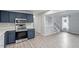 Modern kitchen with blue cabinets and stainless steel appliances at 706 Sleepy Creek Dr, Durham, NC 27713