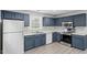 Modern kitchen with blue cabinets and stainless steel appliances at 706 Sleepy Creek Dr, Durham, NC 27713