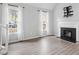 Living room with fireplace, hardwood floors, and large windows at 706 Sleepy Creek Dr, Durham, NC 27713