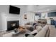 Living room with fireplace, kitchen view, and staged furniture at 706 Sleepy Creek Dr, Durham, NC 27713