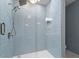 Large walk-in shower with light blue tile and glass enclosure at 706 Sleepy Creek Dr, Durham, NC 27713