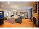 Living room featuring hardwood floors, a large sectional sofa, and a stone fireplace at 8104 Last Oak Court Ct, Raleigh, NC 27613