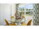 Bright dining area with glass table and four yellow chairs at 8613 Brixton Shay Dr, Raleigh, NC 27616