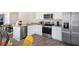 Modern kitchen with white cabinets and stainless steel appliances at 8615 Brixton Shay Dr, Raleigh, NC 27616