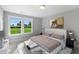 Bedroom with large windows and view of green space at 93 Macy Cir, Wendell, NC 27591