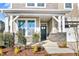 Covered front porch with stone pillars and a dark-colored front door at 93 Macy Cir, Wendell, NC 27591