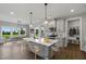 Modern kitchen with island, stainless steel appliances, and eat-in dining area at 93 Macy Cir, Wendell, NC 27591