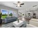 Open living room and kitchen with hardwood floors, island, and view of backyard at 93 Macy Cir, Wendell, NC 27591
