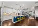 Modern kitchen with white cabinets, large island, and yellow stools at 1013 Catch Fly Ln, Durham, NC 27713