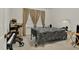 Bright bedroom with a bed, window coverings and a walker at 108 Pinewood Ave, Rocky Mount, NC 27804