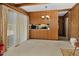Dining area with wood paneling and a view into the kitchen at 108 Pinewood Ave, Rocky Mount, NC 27804