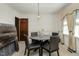 Bright dining room with round table and four chairs, chandelier, and window curtains at 108 Pinewood Ave, Rocky Mount, NC 27804