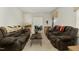 Living room with two brown sofas, a coffee table, and view to dining room at 108 Pinewood Ave, Rocky Mount, NC 27804