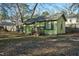 Green wooden shed in backyard with steps and surrounding trees at 108 Pinewood Ave, Rocky Mount, NC 27804