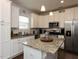 Modern kitchen with white cabinets, granite countertops, and stainless steel appliances at 110 White Ash Ln, Louisburg, NC 27549