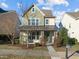 Two-story house with green and beige siding, a metal roof, and a landscaped front yard at 1104 Pemberly Ave, Morrisville, NC 27560