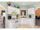 Bright eat-in kitchen features white cabinets, and modern appliances at 1123 Southgate Dr, Raleigh, NC 27610