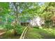 Large backyard view of home featuring a wooden fence, mature trees, and a screened porch at 11712 Black Horse Run, Raleigh, NC 27613