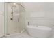 This bathroom features a glass shower, soaking tub, and tile flooring at 11712 Black Horse Run, Raleigh, NC 27613