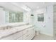 Bright bathroom with double sink vanity, granite countertop, and tiled walk-in shower at 11712 Black Horse Run, Raleigh, NC 27613