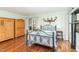 Spacious bedroom with antique wooden wardrobe, hardwood floors, and lots of natural light at 11712 Black Horse Run, Raleigh, NC 27613