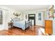 Primary bedroom with hardwood floors, natural light, and antique design elements at 11712 Black Horse Run, Raleigh, NC 27613
