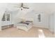 This bedroom features a ceiling fan, carpet, and natural light from windows at 11712 Black Horse Run, Raleigh, NC 27613