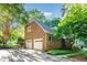 Exterior view of attached two car garage with brick facade and mature landscaping at 11712 Black Horse Run, Raleigh, NC 27613