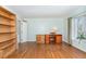 Home office with hardwood floors, built in book shelves, and a large window at 11712 Black Horse Run, Raleigh, NC 27613