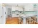 Bright kitchen featuring white cabinets, granite countertops and breakfast bar seating at 11712 Black Horse Run, Raleigh, NC 27613