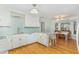 Eat-in kitchen with white cabinets, bar-style seating, and adjoining breakfast nook at 11712 Black Horse Run, Raleigh, NC 27613
